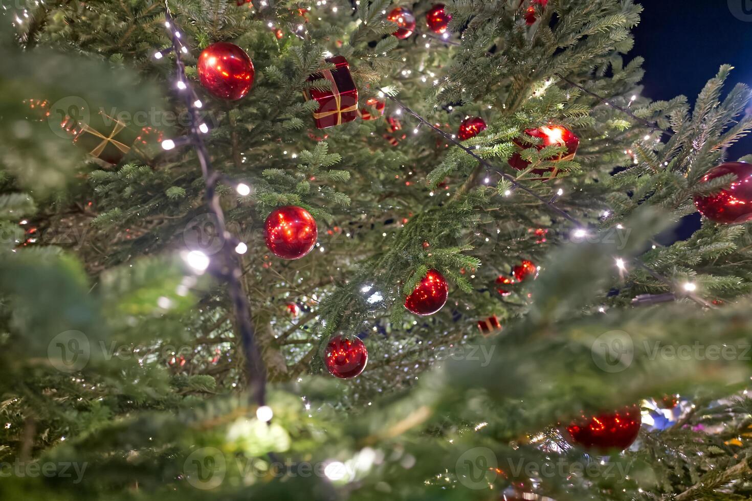 Festive Christmas Tree with Red Ornaments and Lights photo