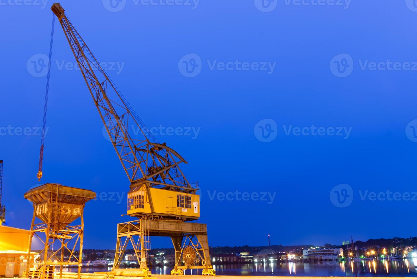 Industrial Crane by the Waterfront at Dusk photo
