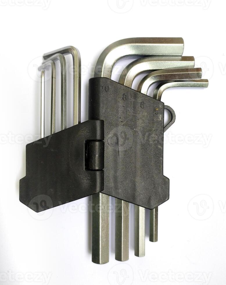 Highangle closeup of a set of Lshaped Allen keys neatly organized in a black plastic holder against a white background. photo