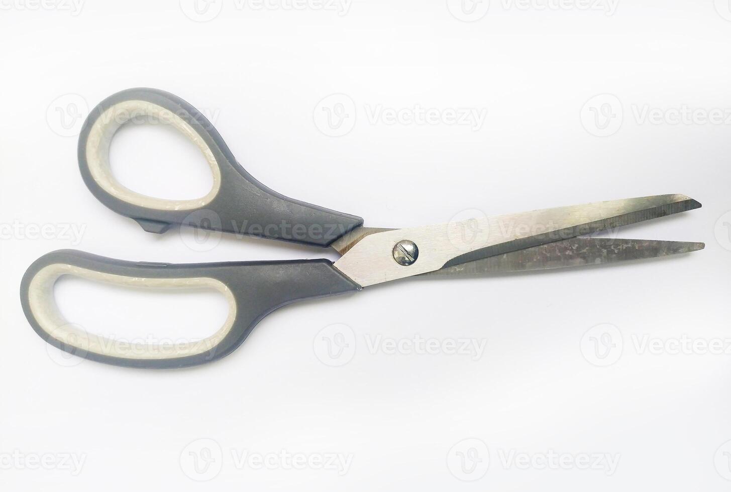 Closeup of grayhandled scissors against a white background. A simple yet versatile image representing cutting, precision, and efficiency. photo