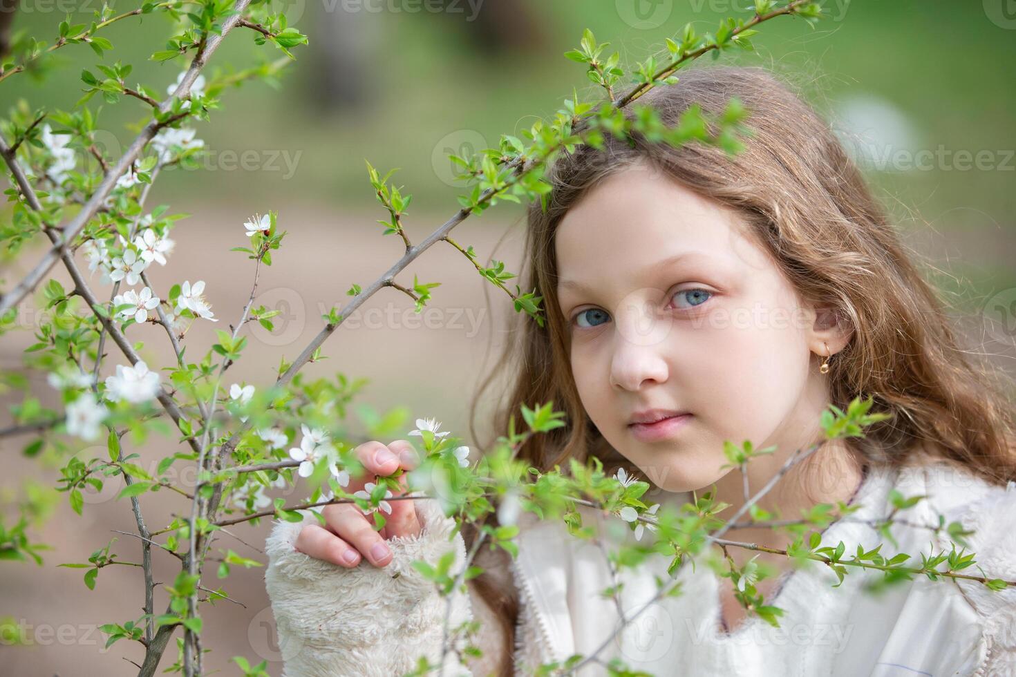Portrait of a beautiful blue-eyed girl with flowers. photo