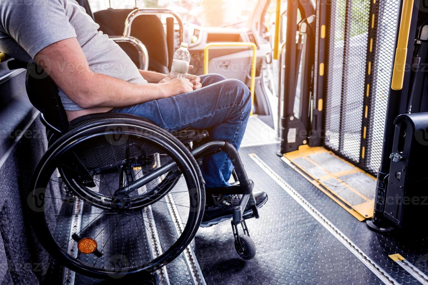 A man in a wheelchair inside of a specialized vehicle photo