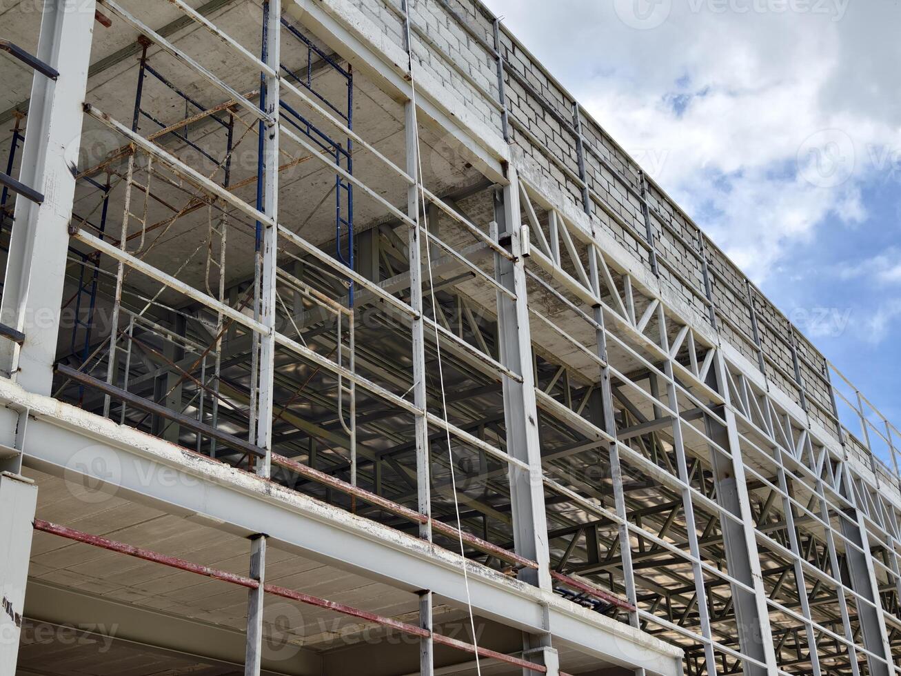 A large and impressive modern building is under construction. photo