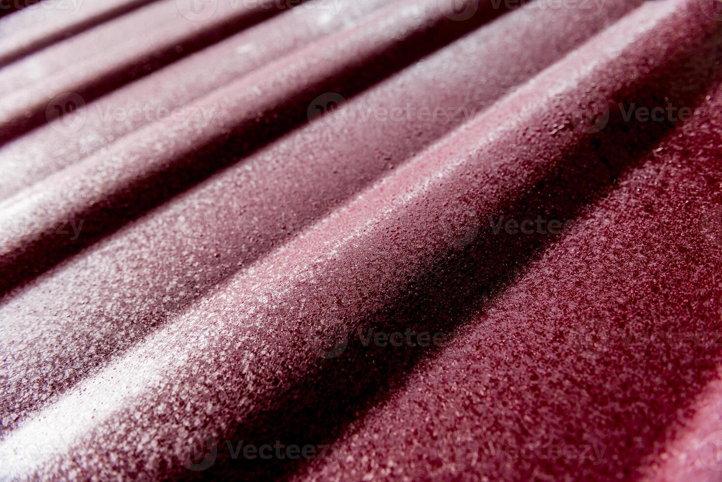 Red metallic roof tiles background with drops of water. photo