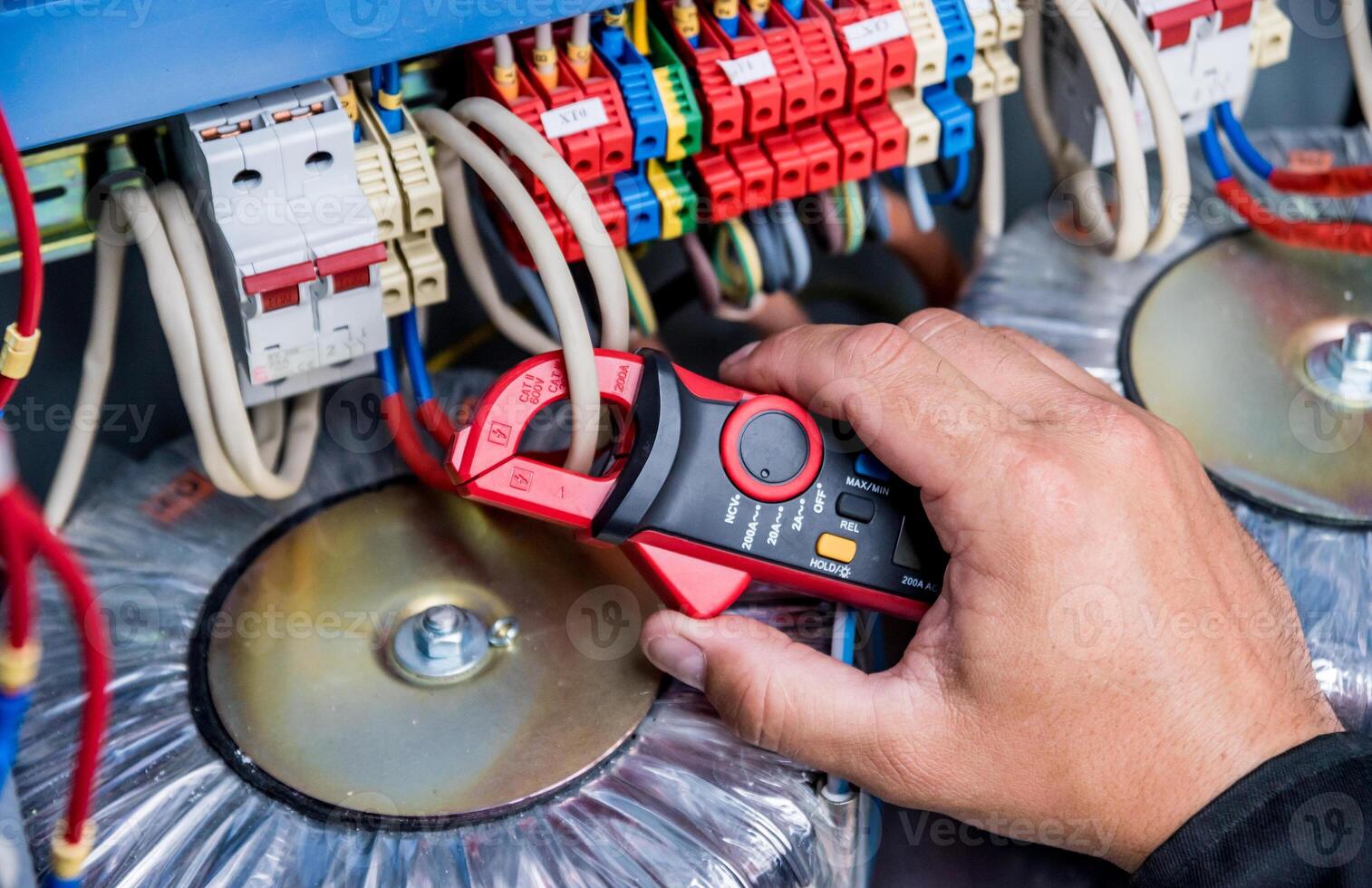Electrical measurements with multimeter tester. Modern electrical background. photo