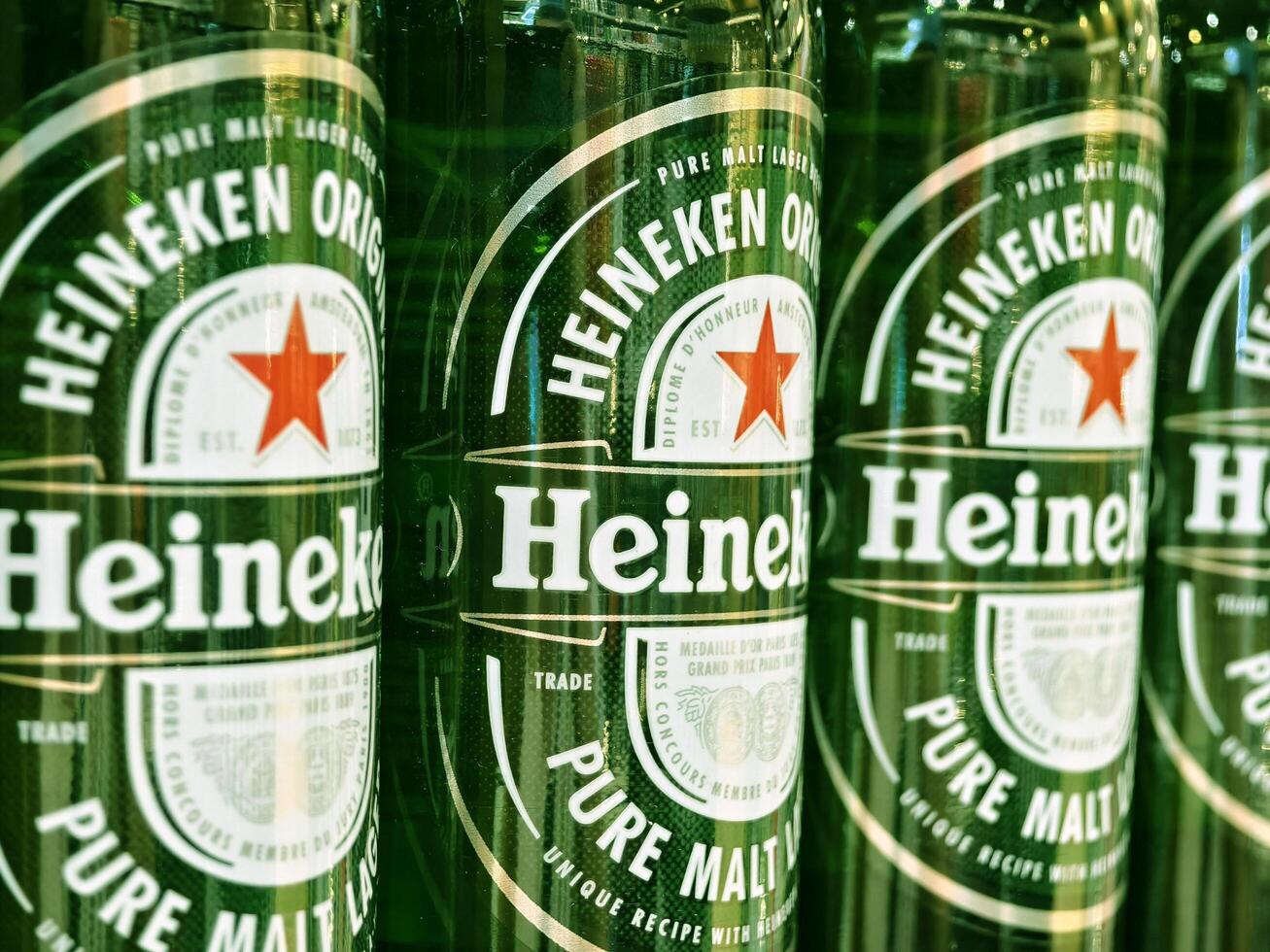 PHUKET, THAILAND - MARCH 8, 2025. Bottles of Heineken beer lined up neatly on a shelf photo