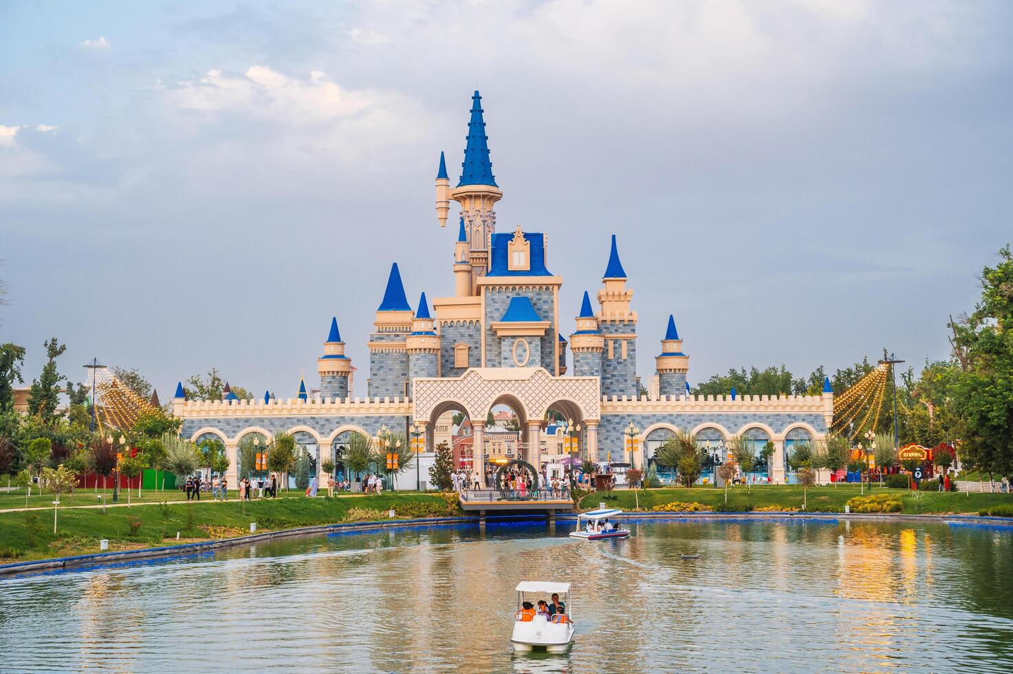 Beautiful fairy-tale castle by lake in Magic City amusement park in Tashkent. Tashkent, Uzbekistan - July 15, 2025 photo