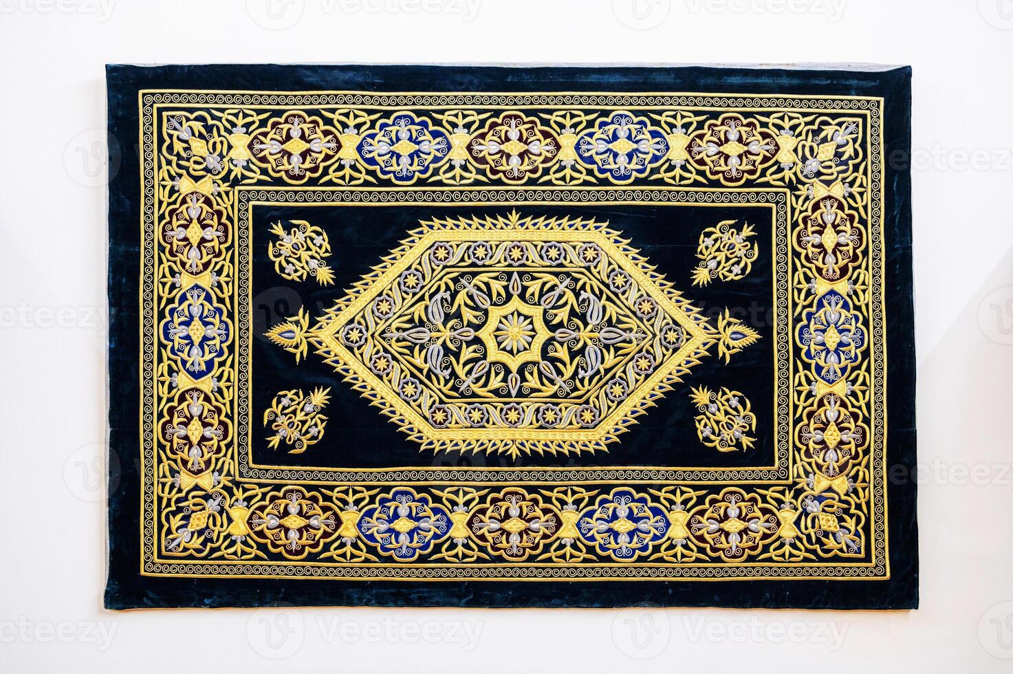 oriental Uzbek carpet with a traditional abstract geometric pattern. Vintage luxury handmade Turkish carpet on white isolated background photo