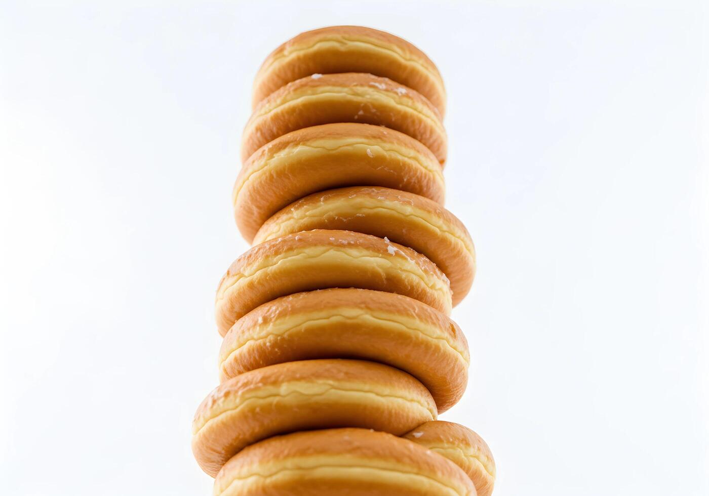 Stacked Fresh Glazed Donuts on White Background Delicious Treat Concept photo