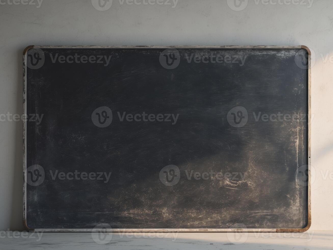 A blackboard is sitting on a white wall photo
