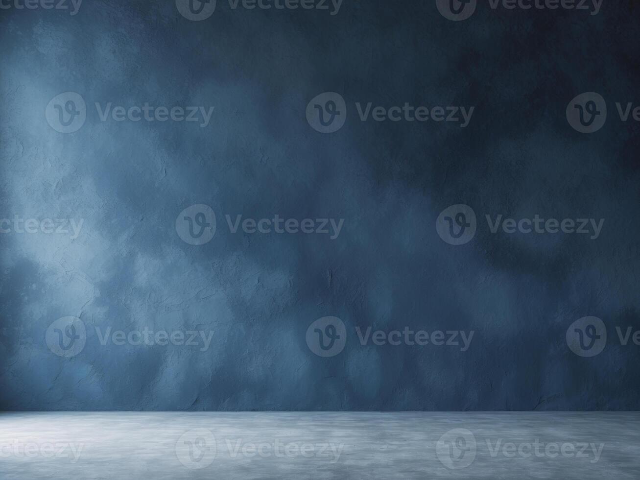 An empty room with a blue wall and concrete floor photo