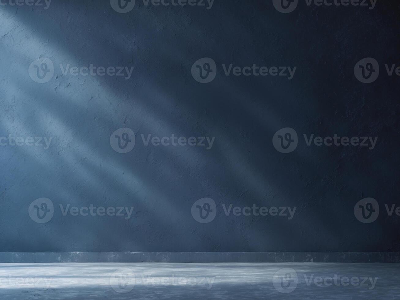 An empty room with a dark wall and floor photo