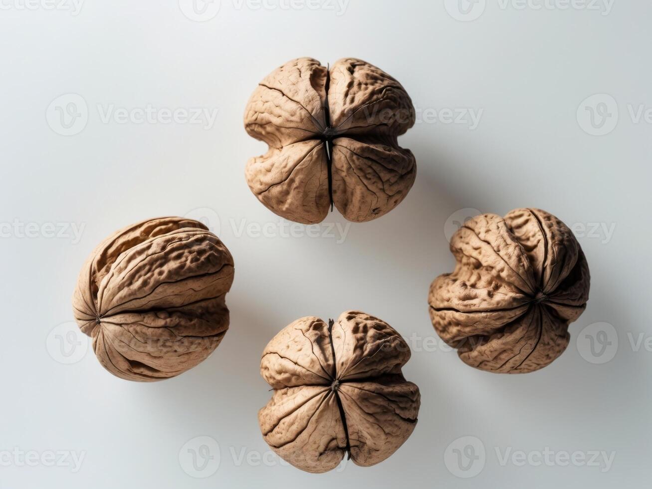 Four walnuts different sizes shapes are arranged triangular Set of delicious photo