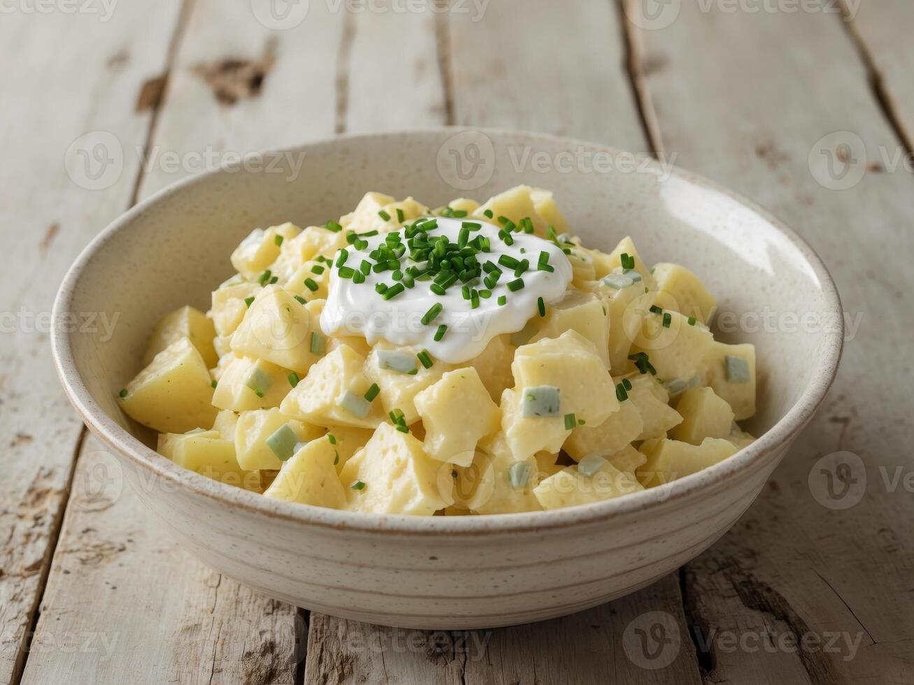Bowl potato salad wooden table is made ceramic Creamy and Delightful Homemade. photo