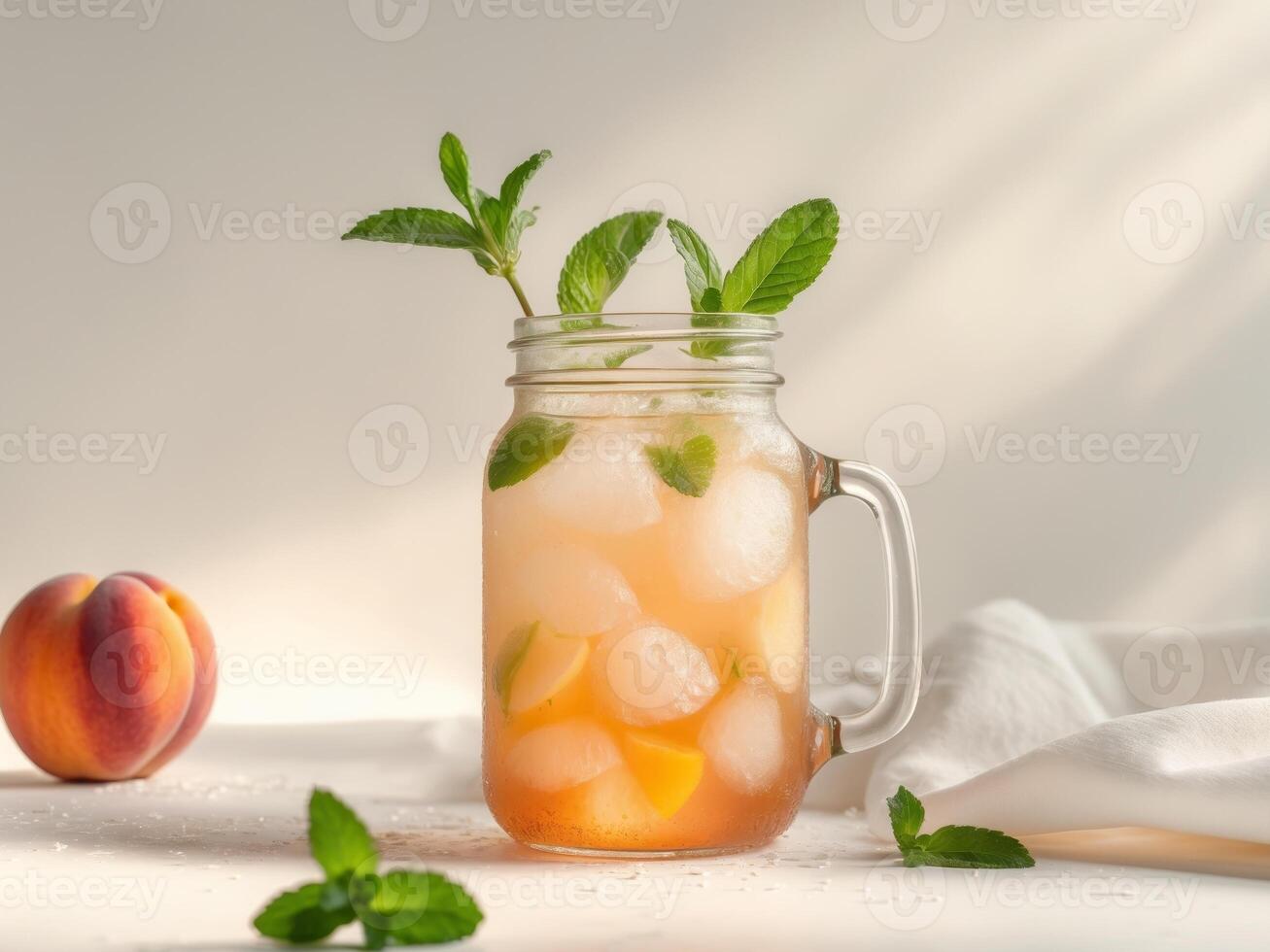High Definition Image of Peach Ice Tea in Mason Jar with Mint. photo