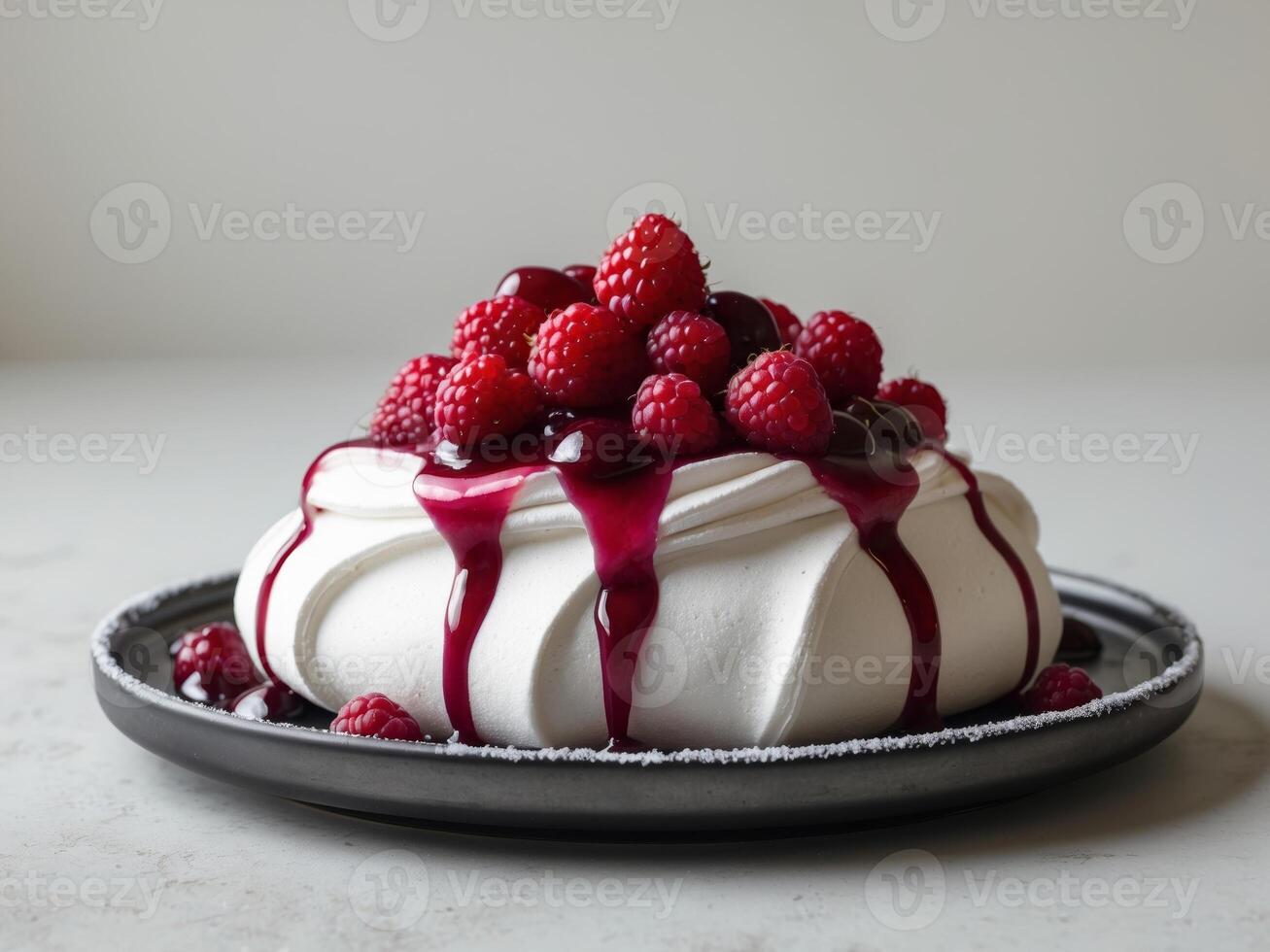 A pavlova with raspberry sauce on top photo