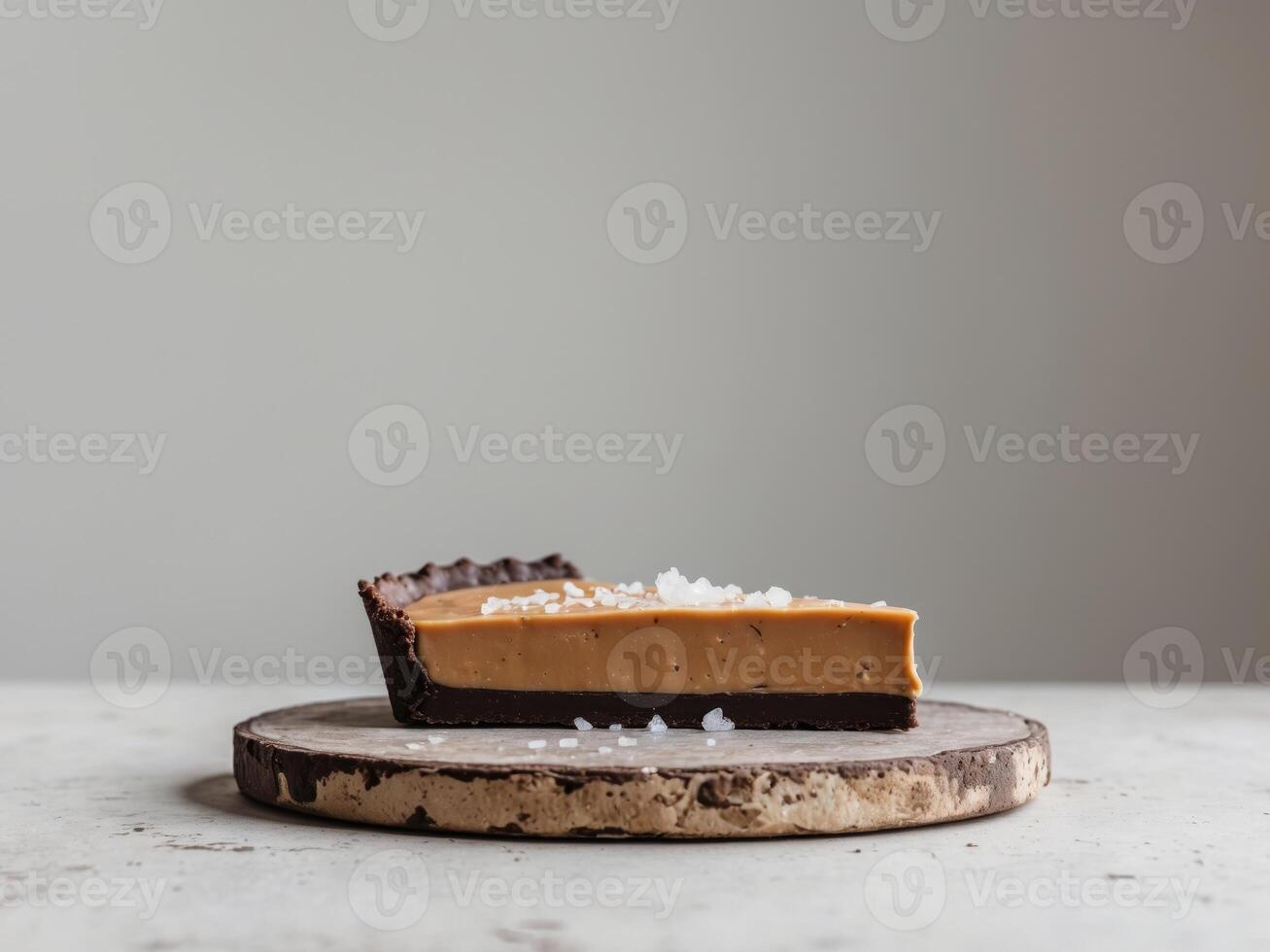 Decadent Chocolate Tart Slice with Rich Peanut Butter Filling and Sea Salt on Rustic Tableware photo