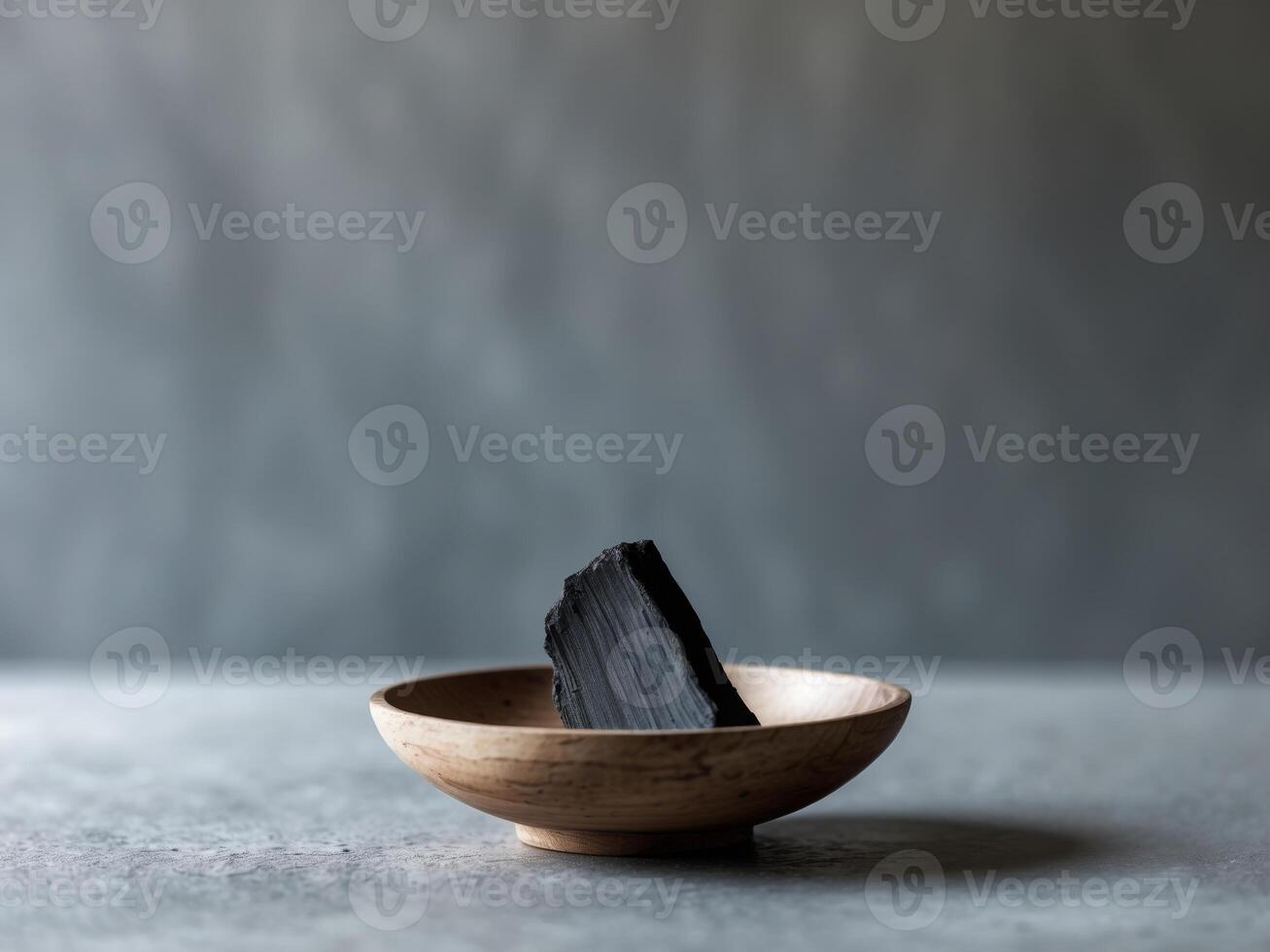 A wooden bowl with charcoal in it photo