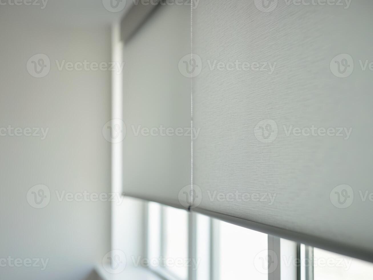 A window with blinds and a white wall photo