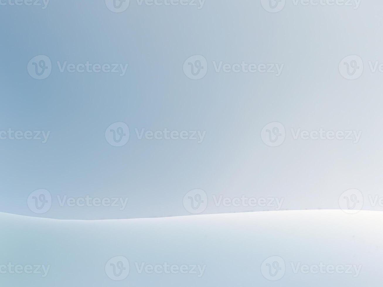 A white snow covered field with a blue sky photo