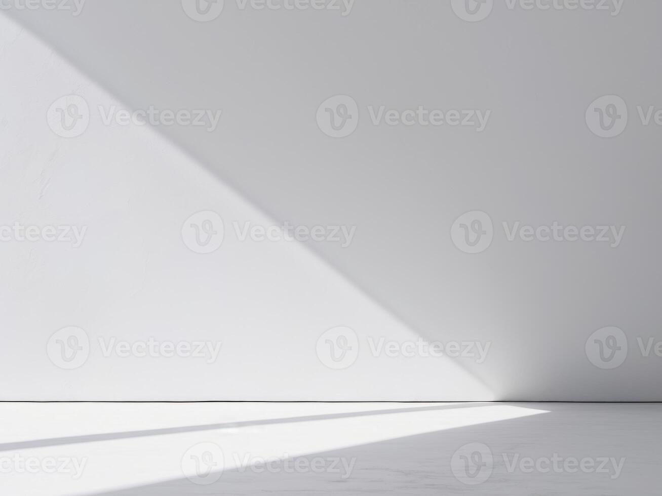 An empty room with a white wall and a light coming in photo