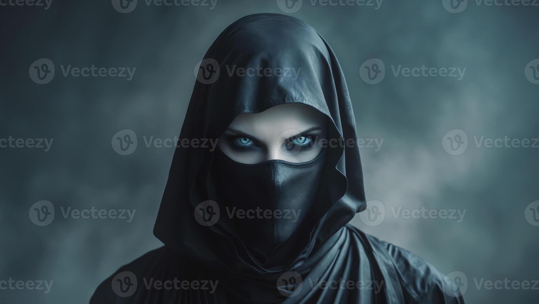 A woman in a black hood with blue eyes photo