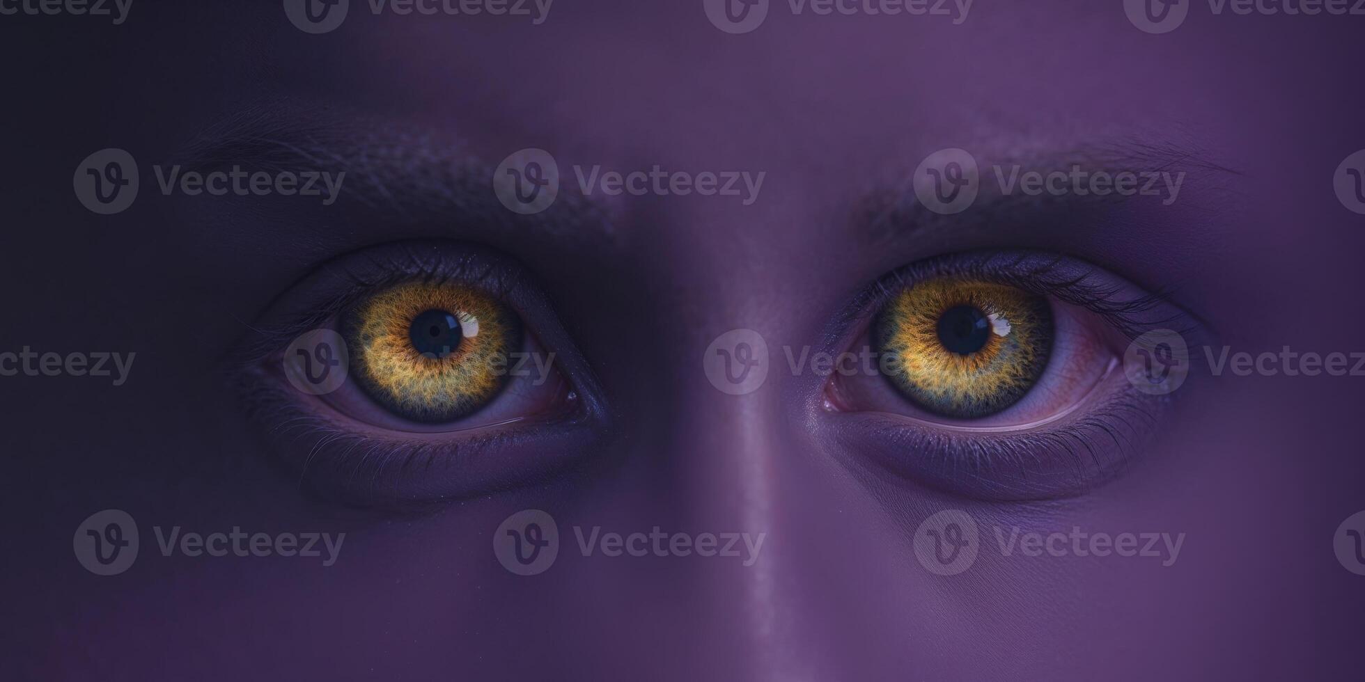 Mysterious golden eyes staring from dark purple background. photo
