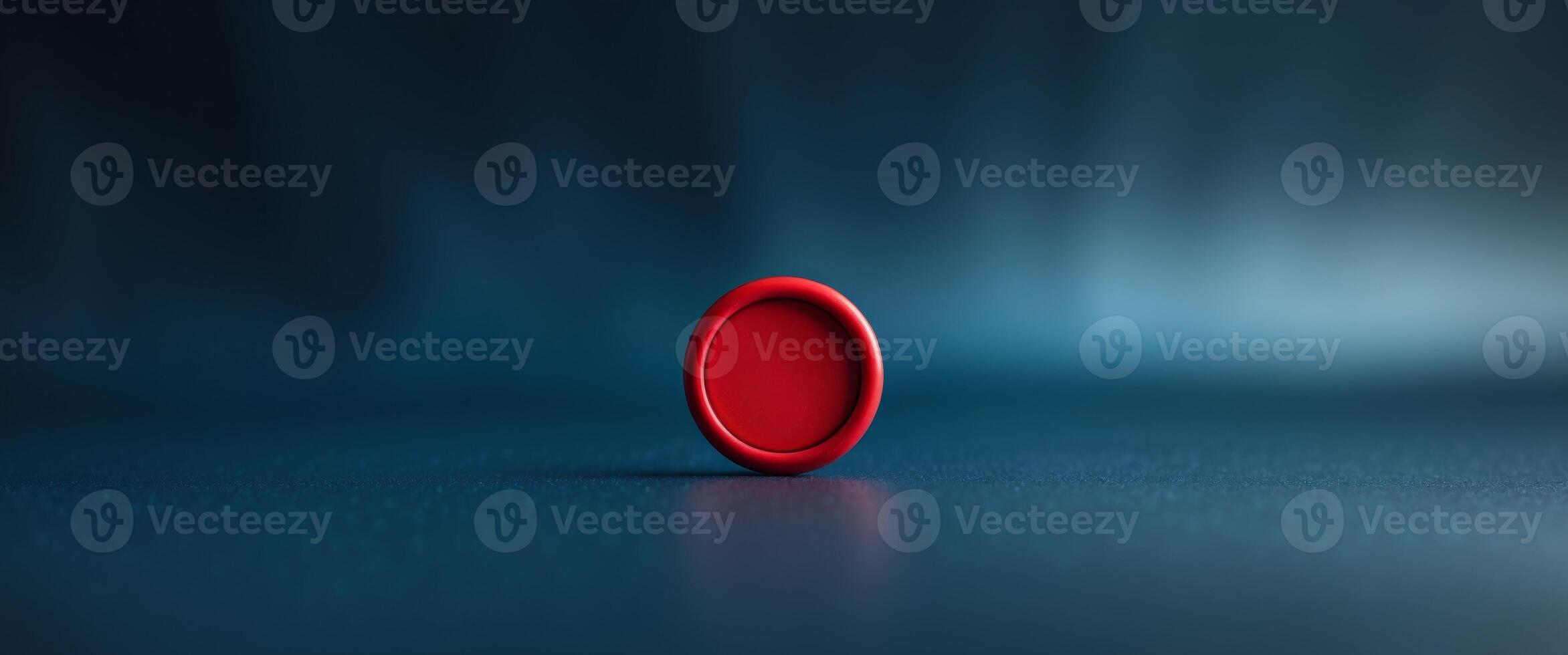 A red button on a blue surface photo