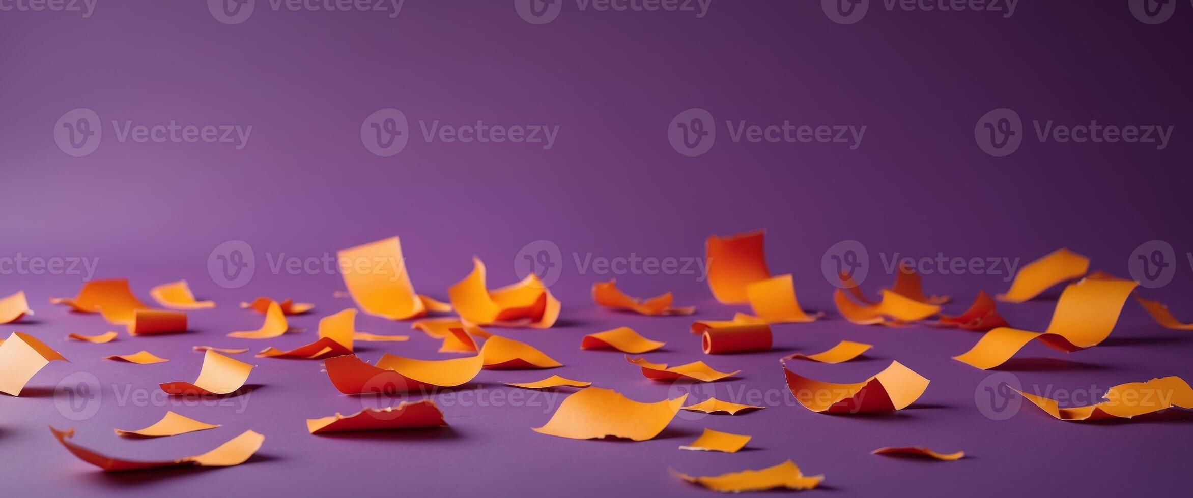 Orange paper pieces scattered on a purple background photo