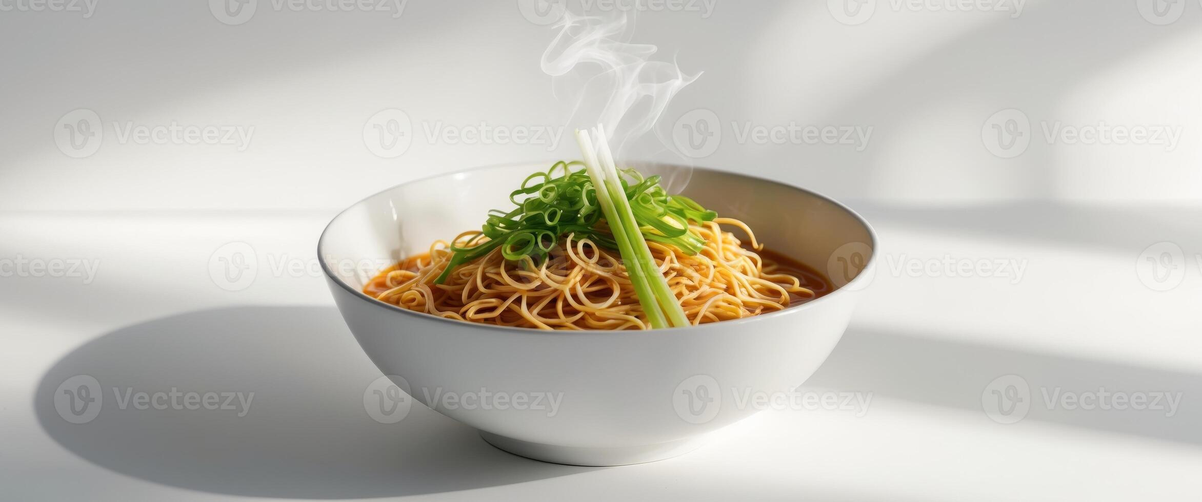 A Bowl of Delicious Noodles Garnished with Fresh Green Onions photo