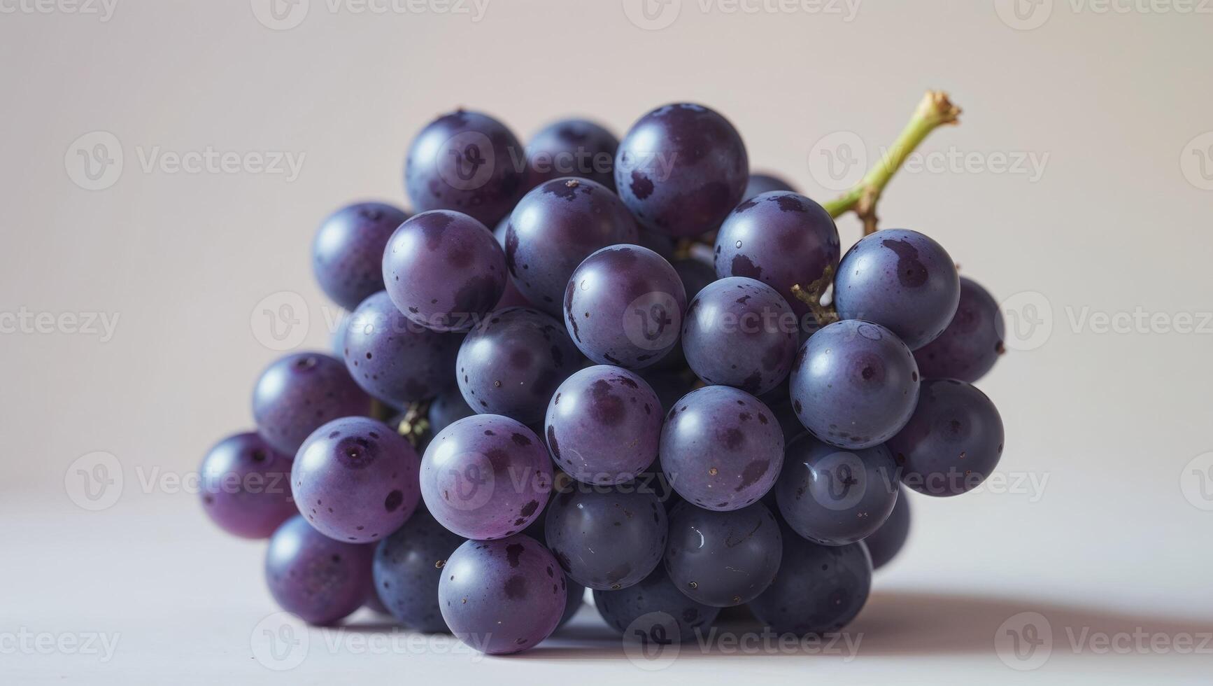 A close up image of a bunch of dark purple grapes. photo