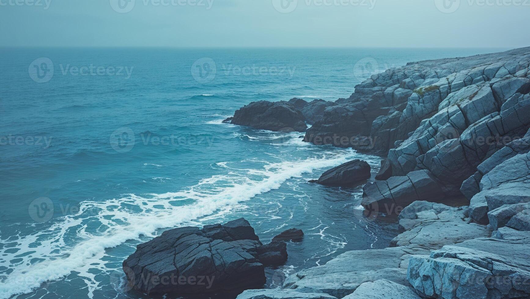 A view of the ocean from a rocky cliff photo
