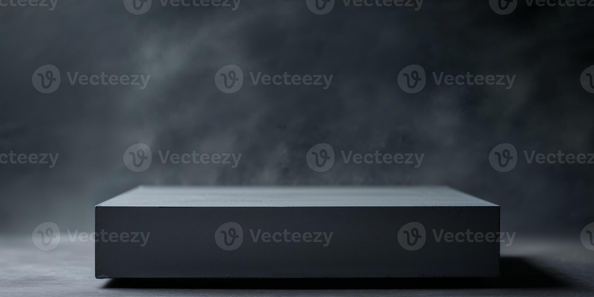 Dark Gray Blank Rectangular Object on Dark Surface photo