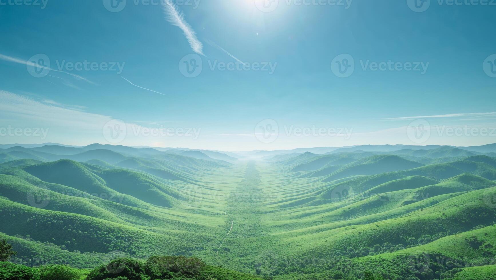 Expansive Panoramic View of Lush Green Valley and Rolling Hills Under a Bright Blue Sky. photo