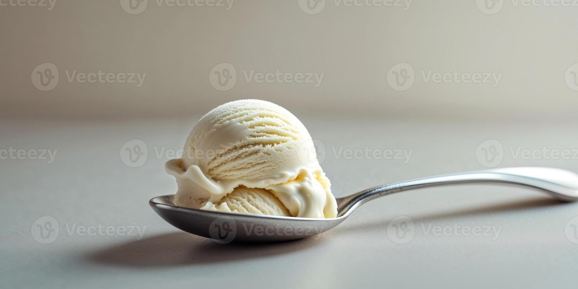 Scoop of Vanilla Ice Cream Melting on a Silver Spoon. photo