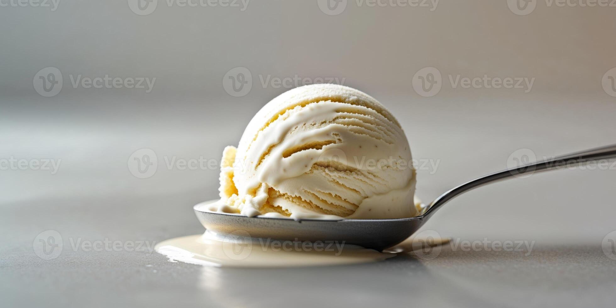 Scoop of Vanilla Ice Cream Melting on a Silver Spoon photo