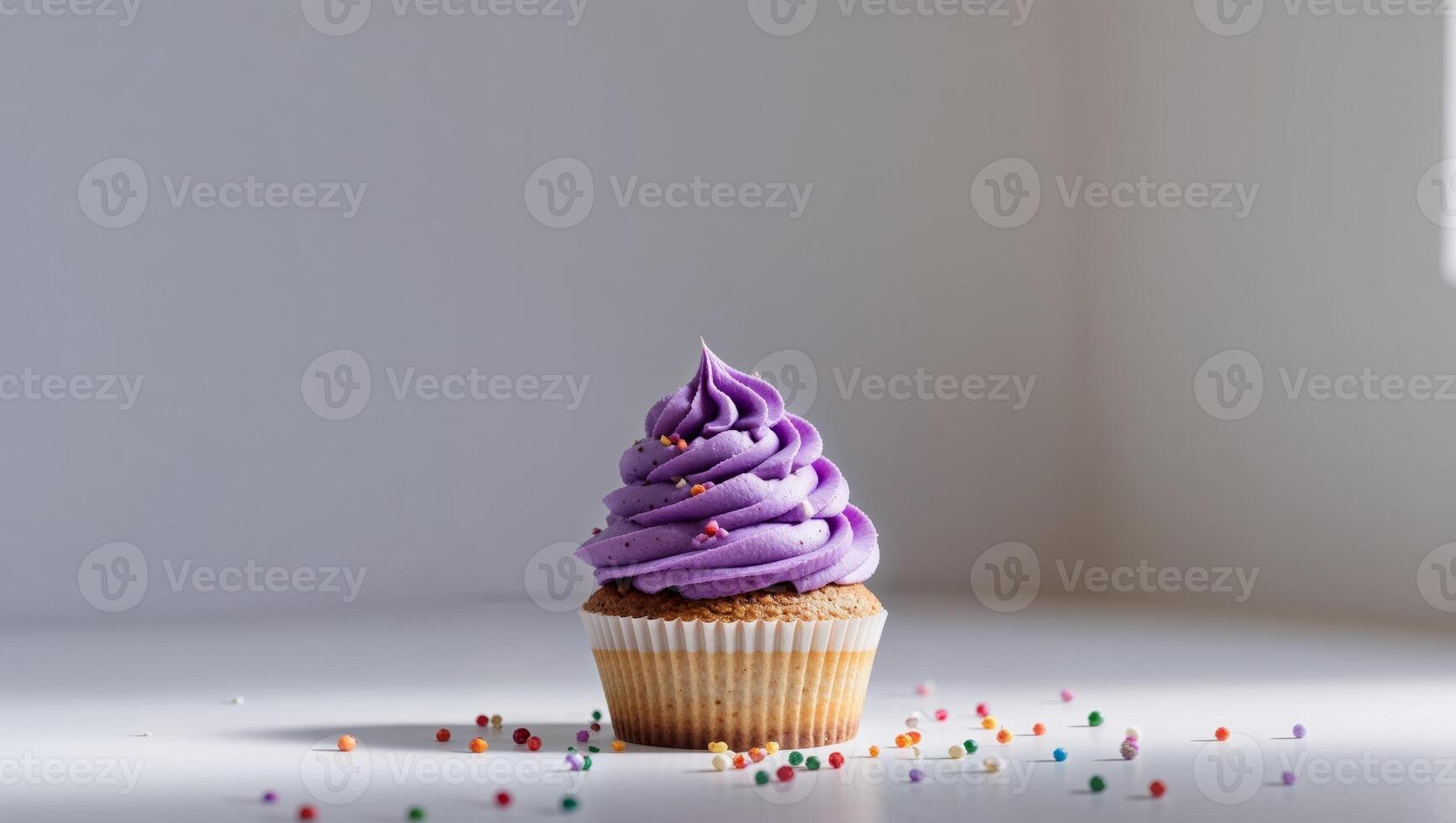 Small Delicious Cupcake with Purple Frosting and Sprinkles. photo