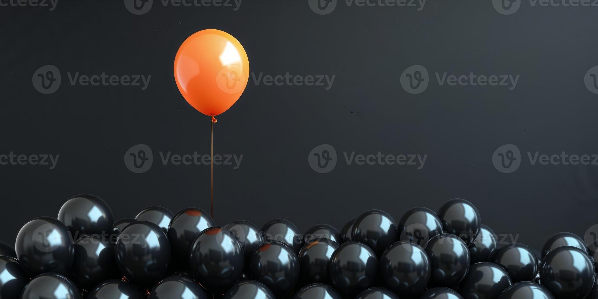 Orange balloon rising above many black balloons on dark background. photo