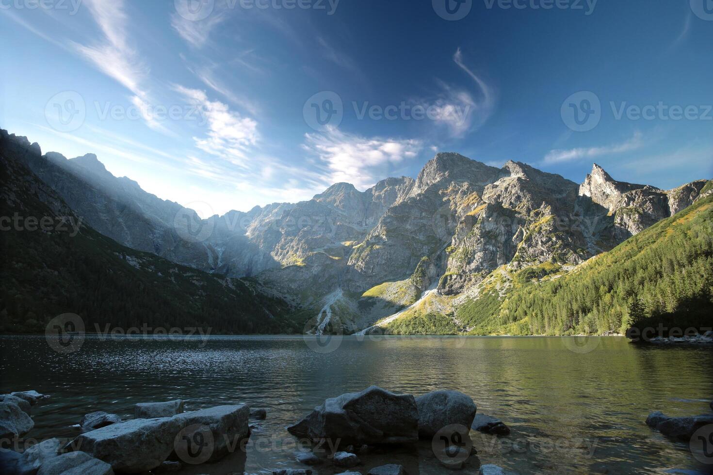 High peaks of the Carpathian Mountains on the edge of the lake photo