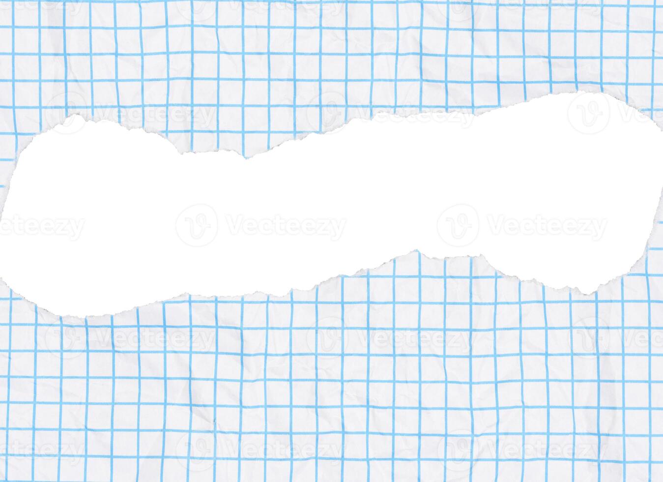 Piece of paper with a light blue grid pattern and a large, torn hole in the center. The paper has a slightly crumpled texture, torn edges are ragged. photo