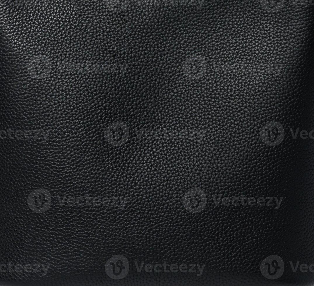 Close-up of black textured leather surface showing detailed grain pattern photo