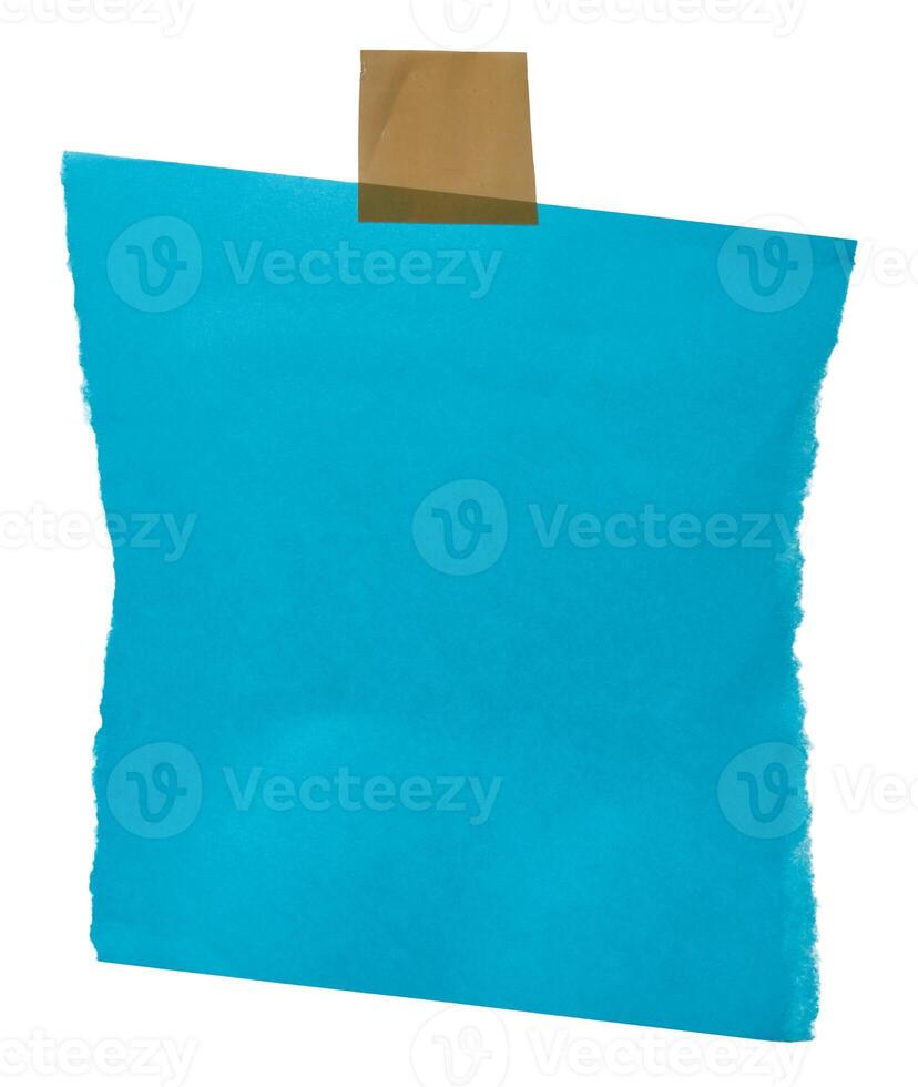 A ripped blue paper sheet with rough edges, secured by beige adhesive tape at the corners, copy space photo
