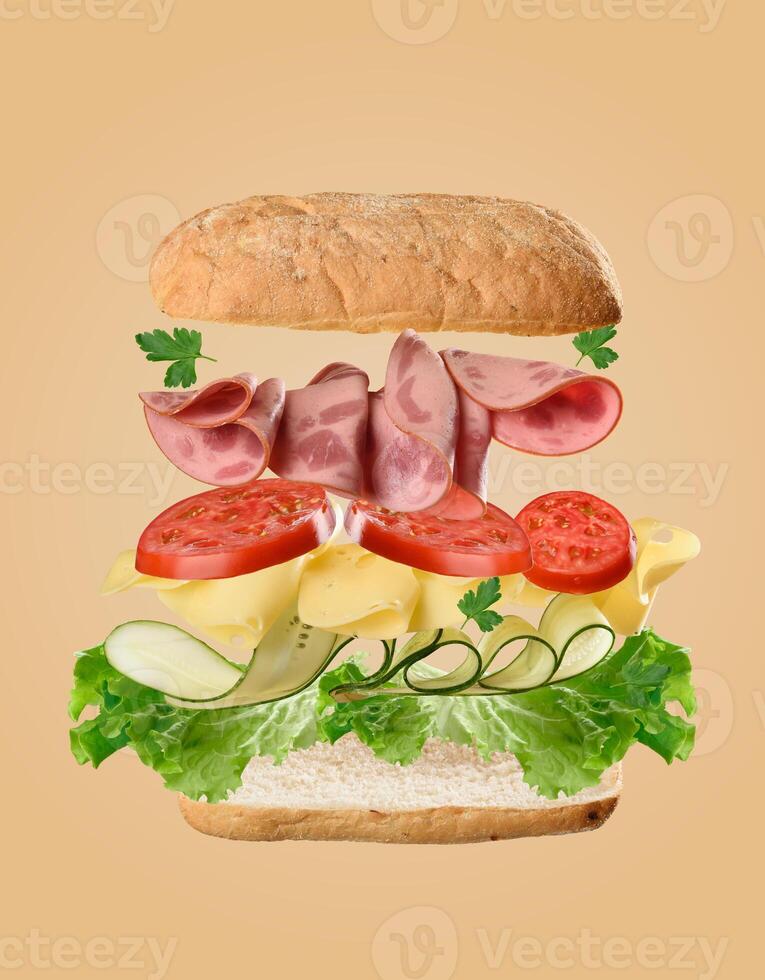 Floating sandwich ingredients bread, tomato slices, parsley, ham, cheese, and cucumber arranged in layers, beige background. photo
