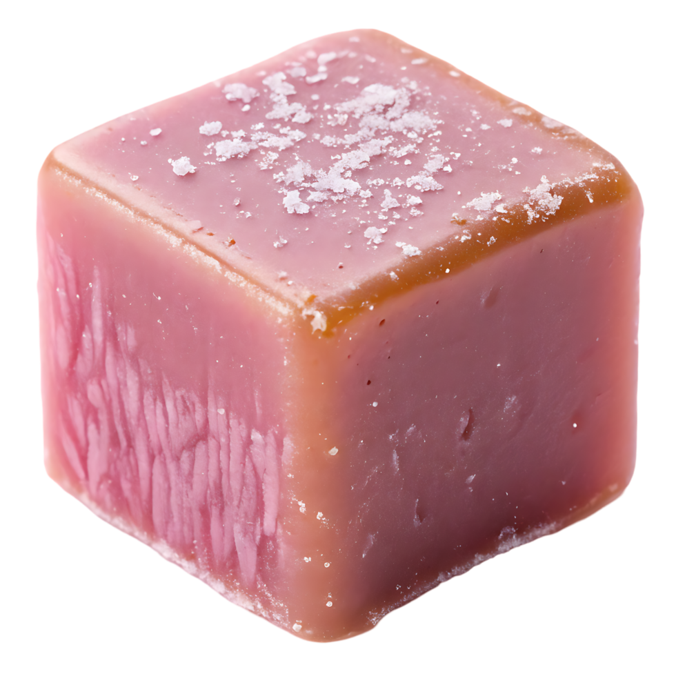 Close up of a single cube of pink salted caramel candy. png