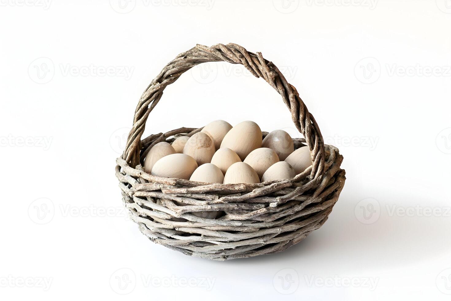 Woven basket filled with wooden eggs on a white background in a studio setting for easter decor photo