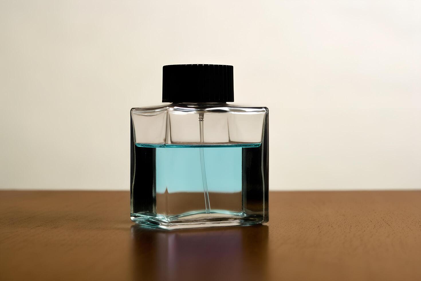 A small blue bottle of perfume sitting on a table photo