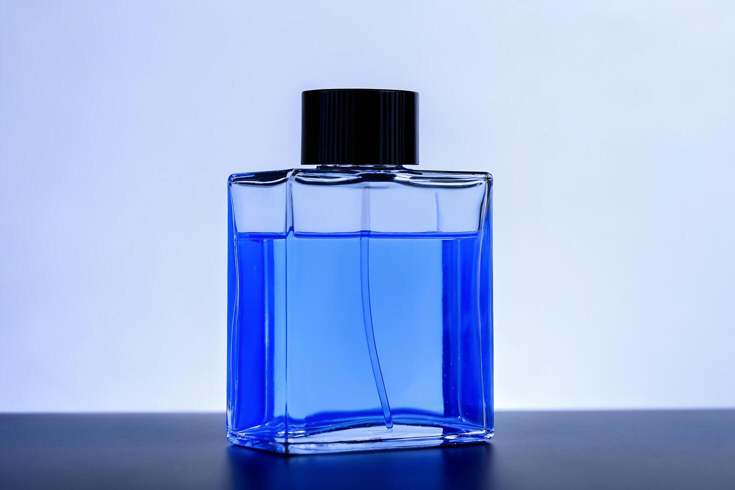 A blue bottle of perfume on a table photo