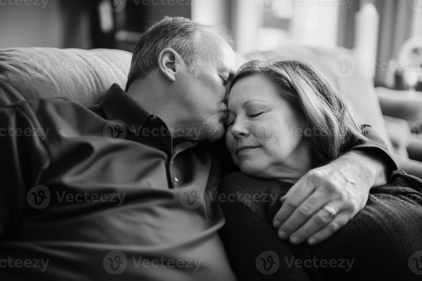 A man and woman are cuddling on a couch photo