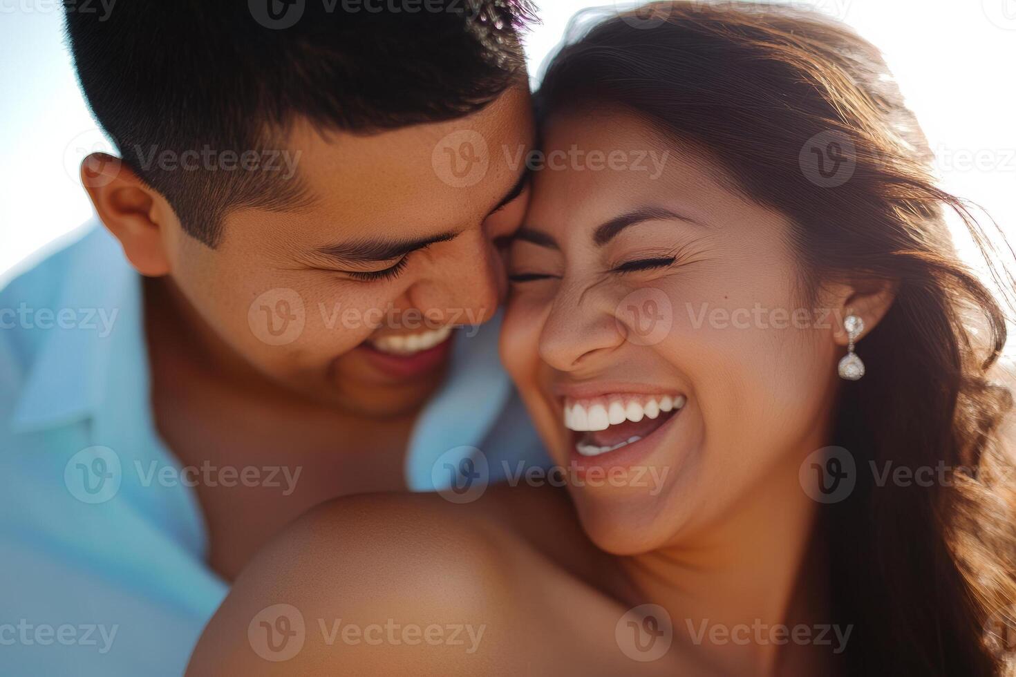 A man and woman laughing together on the beach photo