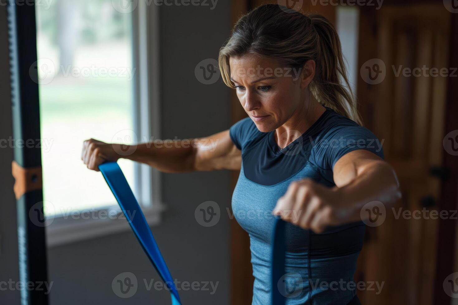 A woman is holding a resistance band in her hand photo